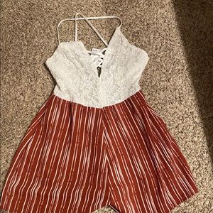 Rue 21 size small romper. Brand new with tags. Color is white and burnt orange.